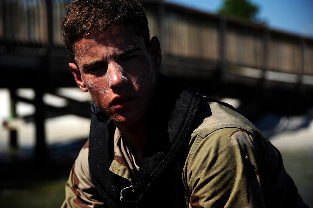 A combat controller from the Special Tactics Training Squadron sits in a pontoon boat prior to jumping in the water, Hurlburt Field, Fla., Oct. 6, 2011.  The STTS Airman was preparing to complete a 2,000-meter swim. (U.S. Air Force Photo/Airman Naomi M. Griego)(Released)