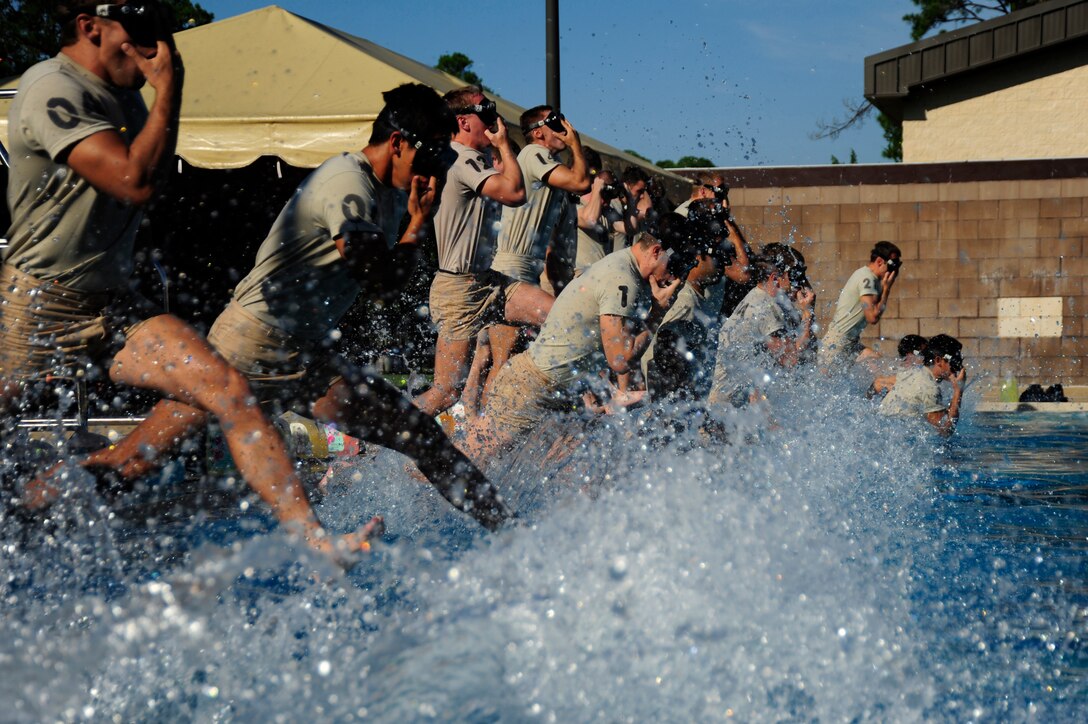 U.S. Air Force Airmen from the Special Tactics Training Squadron jump into their pool during water confidence training evaluation, Hurlburt Field, Fla., Sept. 30, 2011. To advance in training, STTS Airmen are required to successfully complete water confidence training. (U.S. Air Force Photo/Airman Naomi M. Griego)(Released)