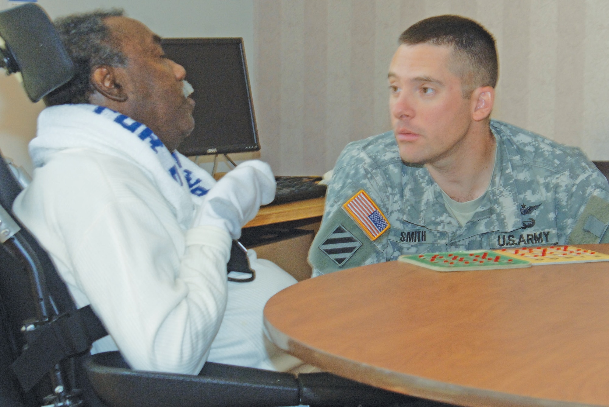 Hampton Veterans Administration Medical Center resident Linwood Clark, left, and Army Lt. Col. Dana Smith have a discussion during a VA bingo game at the medical facility Oct. 3. (U.S. Army photo by Patricia Radcliffe/RELEASED)