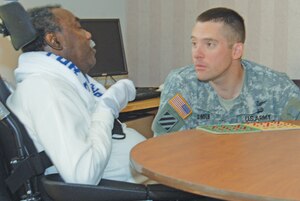 Hampton Veterans Administration Medical Center resident Linwood Clark, left, and Army Lt. Col. Dana Smith have a discussion during a VA bingo game at the medical facility Oct. 3. (U.S. Army photo by Patricia Radcliffe/RELEASED)