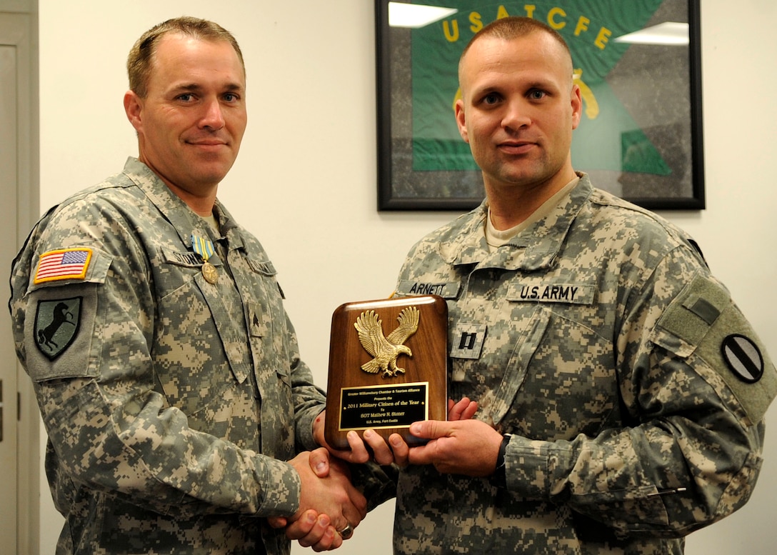 Sgt. Matthew Stoner (left), 221st Military Police Detachment, pictured with Capt. Samuel Arnett, 221st MP Det. commander, received the 2011 Military Citizen of the Year Award from the Greater Williamsburg Chamber of Commerce and Tourism Board during a ceremony Sept. 28 at the Great Wolf Lodge in Williamsburg. (U.S. Air Force photo by Staff Sgt. Dana Hill/RELEASED)
