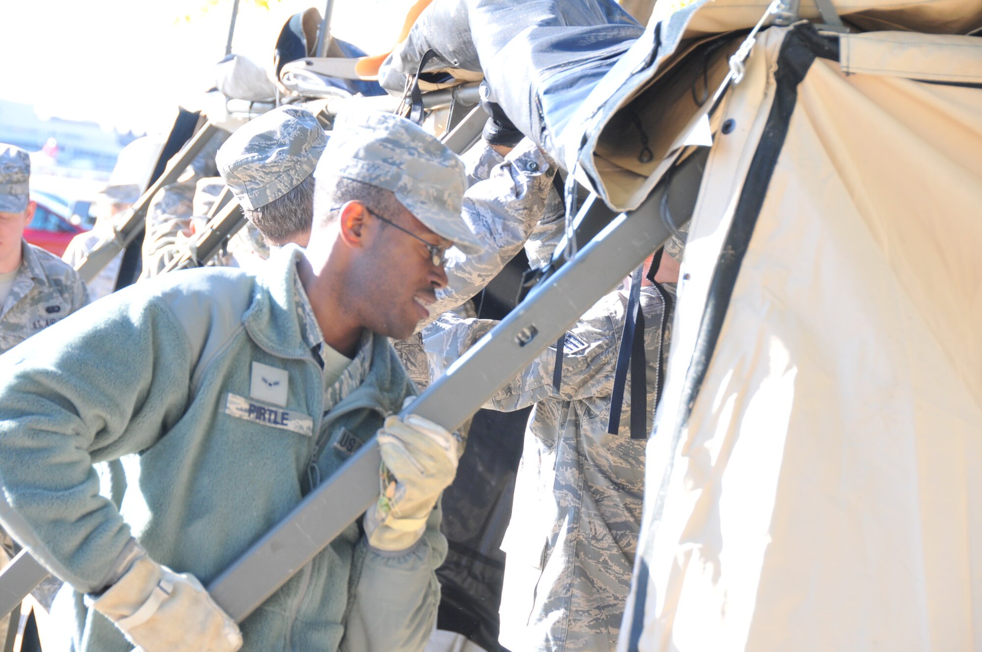 Airman 1st Class Dante Pirtle helps set up a tent during the 934th Force Support Squadron exercise Oct.1.  Reservists trained on setting up a Single Pallet Expeditionary Kitchen which is used to feed Airmen at deployed locations. (Air Force Photo/Tech. Sgt. Jeffrey Williams).