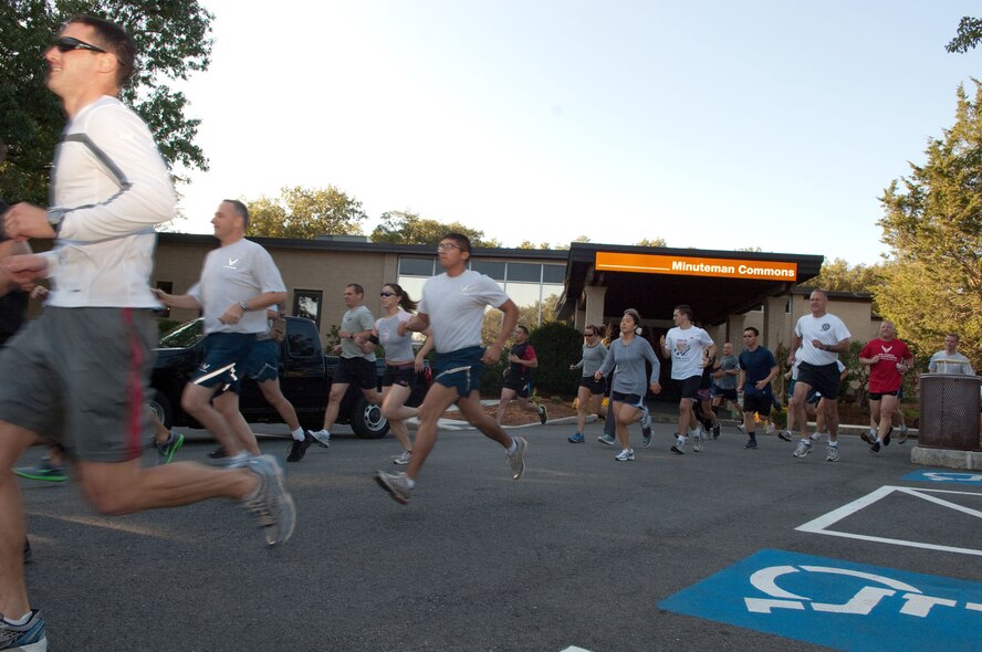 HANSCOM AIR FORCE BASE, Mass. – Runners take off during the Company Grade Officers Council “Crash the Commons” road race that started and ended at the Minuteman Commons Oct. 6. The race was sponsored by Domestic Violence Services Network as part of Domestic Violence Prevention and Awareness Month. (U.S. Air Force photo by Mark Herlihy) 