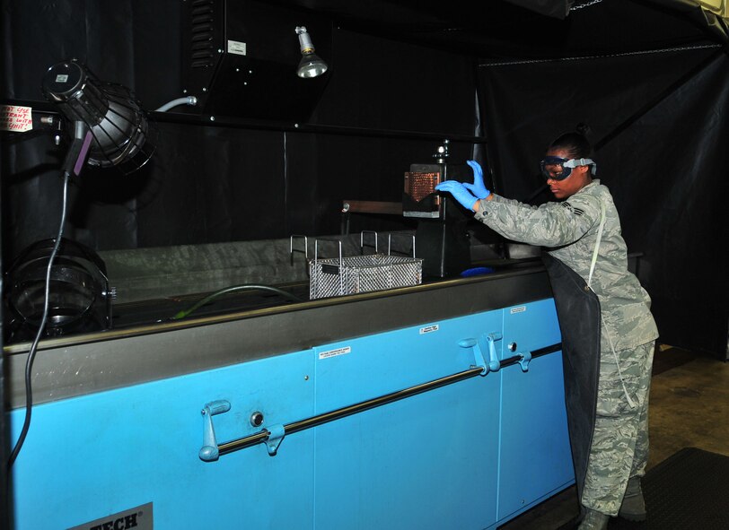 Senior Airman Natasha Abrams prepares to inspect bolts from a KC-135 Stratotanker for cracks and deformities using a Penetrant Inspection System (PIS) at the 4th Equipment Maintenance Squadron non-destructive inspection (NDI) lab on Seymour Johnson Air Force Base, N.C., Oct. 6, 2011., Airmen use the PIS and x-ray equipment to detect defects and abnormalities on specific parts of the aircraft in which damages cannot be easily detected. Abrams is the only active duty Airman at the 916th Air Refueling Wing NDI flight that works on maintaining KC-135s and she hails from Deerfield Beach, Fla. (U.S. Air Force photo by Senior Airman Marissa Tucker)