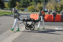 Members of 90th Medical Group transport wounded Senior Airman Danielle Johnson, 90th Security Support Squadron, to the hospital during a base exercise here Sept. 21. The exercise scenario was a chemical explosion. (U.S. Air Force photo by Blaze Lipowski)