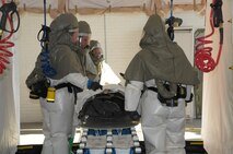 Members of 90th Medical Group assist wounded Senior Airman Danielle Johnson, 90th Security Support Squadron, during a base exercise here Sept. 21. (U.S. Air Force photo by Blaze Lipowski)
