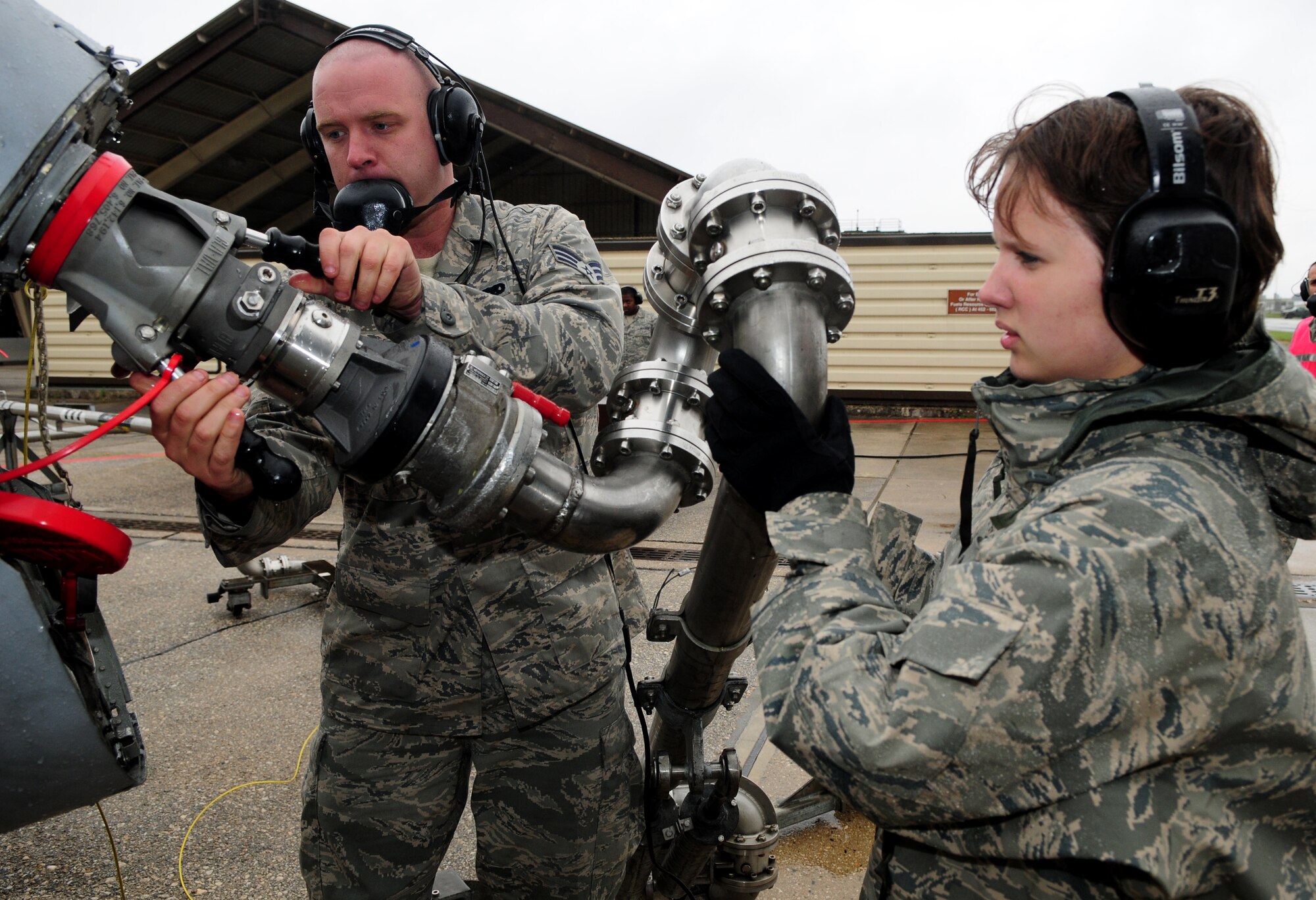 SPANGDAHLEM AIR BASE, Germany – Airman 1st Class Heather Dixon, 52nd Logistics Readiness Squadron fuels apprentice, and Senior Airman Steven Snyder, 52nd Aircraft Maintenance Squadron A-10 avionics journeyman, secure a Type-4 hydrant system to an A-10 Thunderbolt II during hot-pit refueling here Oct. 13. Hot-pit refueling saves time, manpower and equipment usage by using a Type-4 hydrant system to refuel aircraft while they are still running between training missions. (U.S. Air Force photo/Airman 1st Class Matthew B. Fredericks)