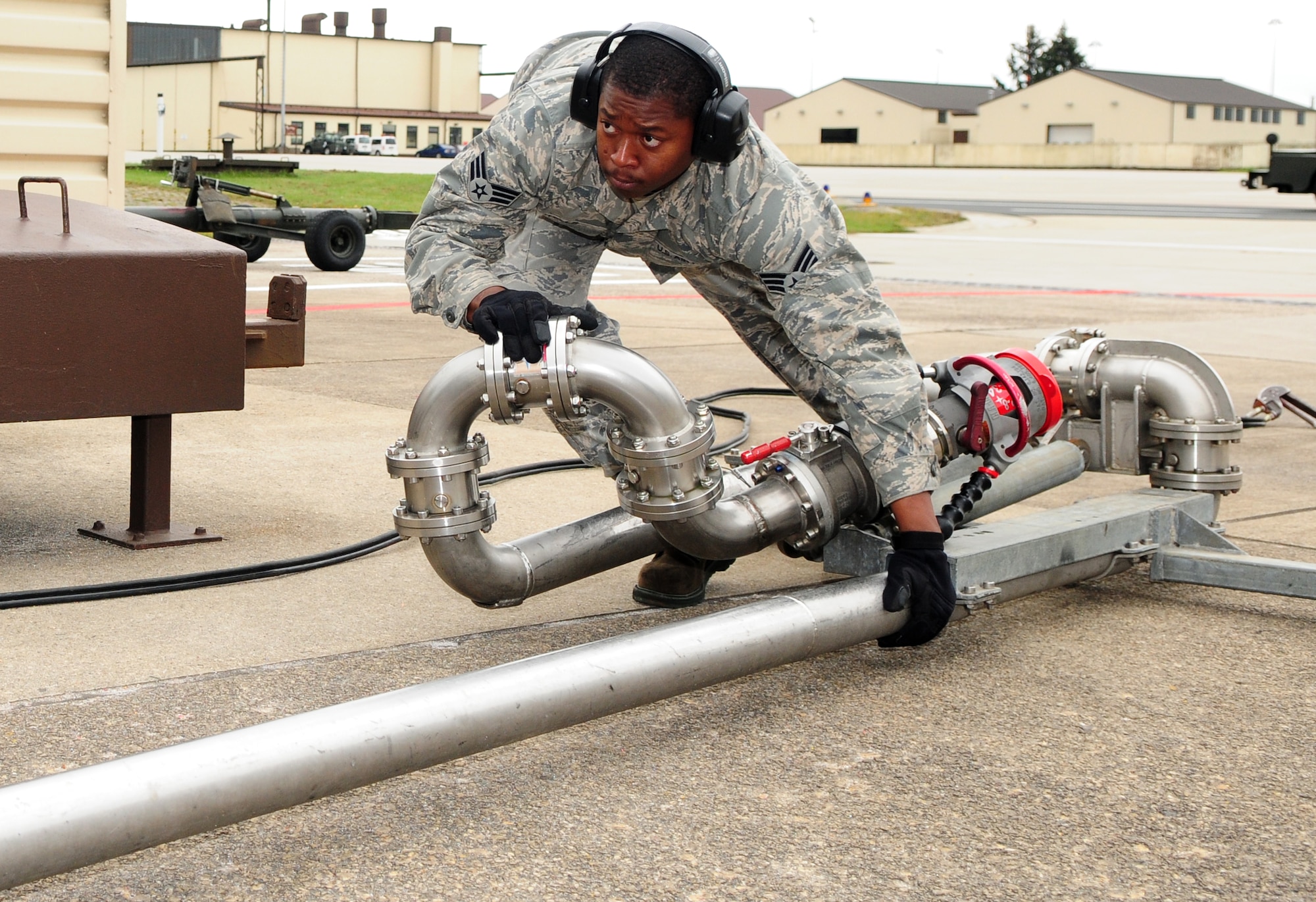 SPANGDAHLEM AIR BASE, Germany – Senior Airman Jason Wells, 52nd Logistics Readiness Squadron refueling maintenance technician, repositions the pipeline from a Type-4 hydrant system used to refuel 52nd Fighter Wing aircraft during hot-pit refueling here Oct. 13. Hot pit refueling saves time, manpower and equipment usage by using a Type-4 hydrant system to refuel aircraft while they are still running between training missions. (U.S. Air Force photo/Airman 1st Class Matthew B. Fredericks)