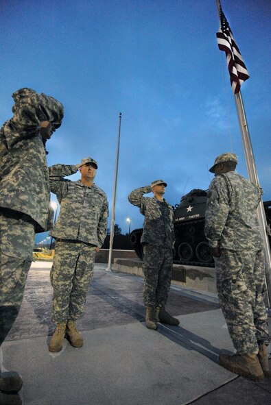 U.S. Army Sgt. 1st Class Brian Meeks, 3rd Army Central G2 analysis and control element, Sgt. 1st Class James Lee, 3rd Army Central G1 policy and program NCO, Spc. Jedidiah Sevrey, 3rd Army Central G2 analyst, and Sgt. Jasmar Briscoe, 3rd Army Central G1 strength management NCO, salute the American flag during reveille Shaw Air Force Base, S.C., Oct. 13, 2011. 6:50 a.m. 3rd Army Central raises the flag for reveille every morning. (U.S. Air Force photo by Airman 1st Class Tabatha Duarte/Released)