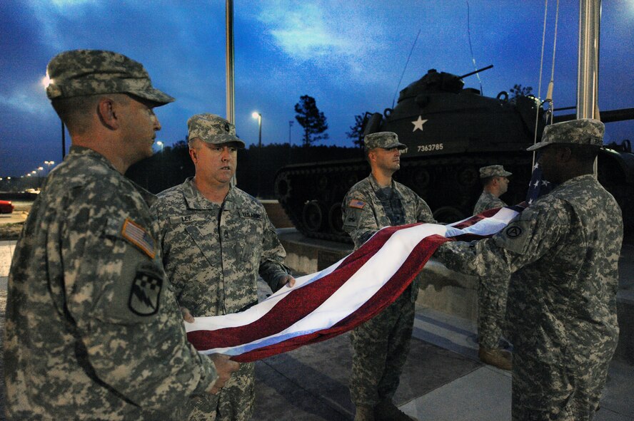 U.S. Army Sgt. 1st Class Brian Meeks, 3rd Army Central G2 analysis and control element, Sgt. 1st Class James Lee, 3rd Army Central G1 policy and program NCO, Spc. Jedidiah Sevrey, 3rd Army Central G2 analyst, Sgt. Samuel Laymance, 3rd Army Central G2 human intelligence collector, and Sgt. Jasmar Briscoe, 3rd Army Central G1 strength management NCO, hold the American flag before reveille, Shaw Air Force Base, S.C., Oct. 13, 2011. 6:50 a.m. 3rd Army Central raises the flag for reveille every morning. (U.S. Air Force photo by Airman 1st Class Tabatha Duarte/Released)