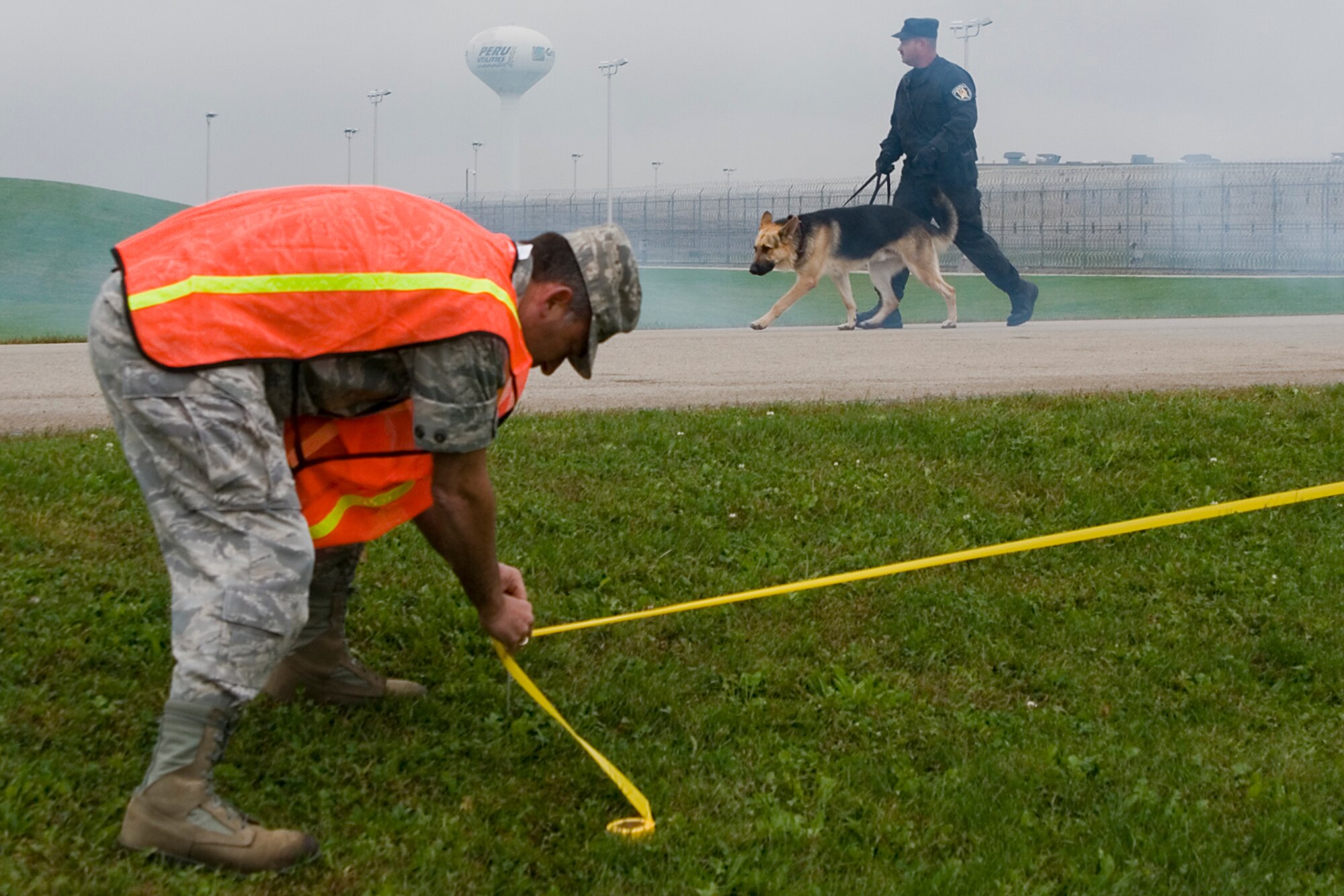 GRISSOM AIR RESERVE BASE, Ind. -- Lt. Col. Gregory DeMaio, 434th Air Refueling Wing performance planning officer, marks off the area of a simulated aircraft crash site outside the Miami Correctional Facility. The Grissom Fire Department took part in an emergency response training exercise on the perimeter of the prison. GFD responds to emergencies in the local area outside of the base. (U.S. Air Force photo/Senior Airman Andrew McLaughlin)   