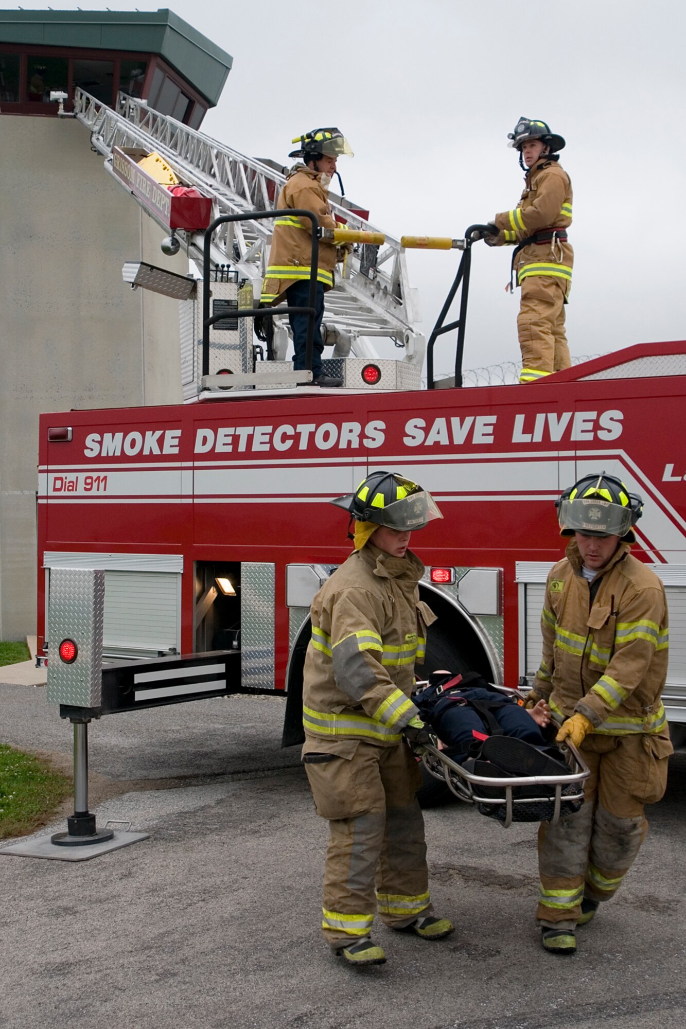 GRISSOM AIR RESERVE BASE, Ind. -- Two firemen from the Pipe Creek Volunteer Fire Department carry away a simulated injured guard that was rescued from a tower by Grissom firefighters at the Miami Correctional Facility. The Grissom Fire Department took part in an emergency response exercise scenario where an airplane crashed on the perimeter of the prison. GFD responds to emergencies in the local area outside of the base. (U.S. Air Force photo/Senior Airman Andrew McLaughlin)   