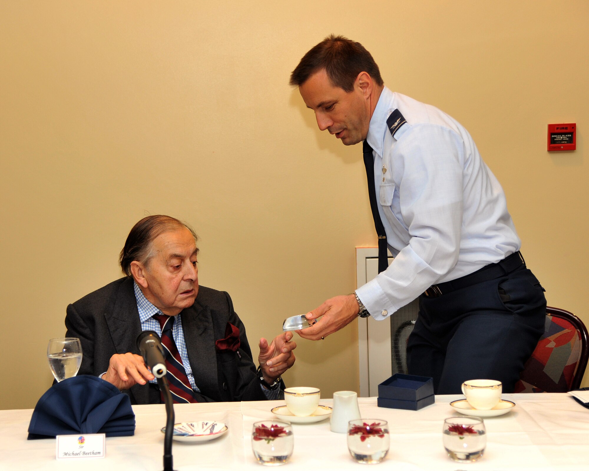 RAF MILDENHALL, England – Col. Christopher Kulas, 100th Air Refueling Wing commander, presents a token of appreciation to Sir Michael Beetham during a recent visit to the base Oct. 11, 2011. Beetham joined the Royal Air Force in May 1941, eventually becoming a bomber pilot. He has flown missions in the Battle of Berlin and World War II, and is presently the most senior RAF marshal. (U.S. Air Force photo/Senior Airman Jerilyn Quintanilla)  