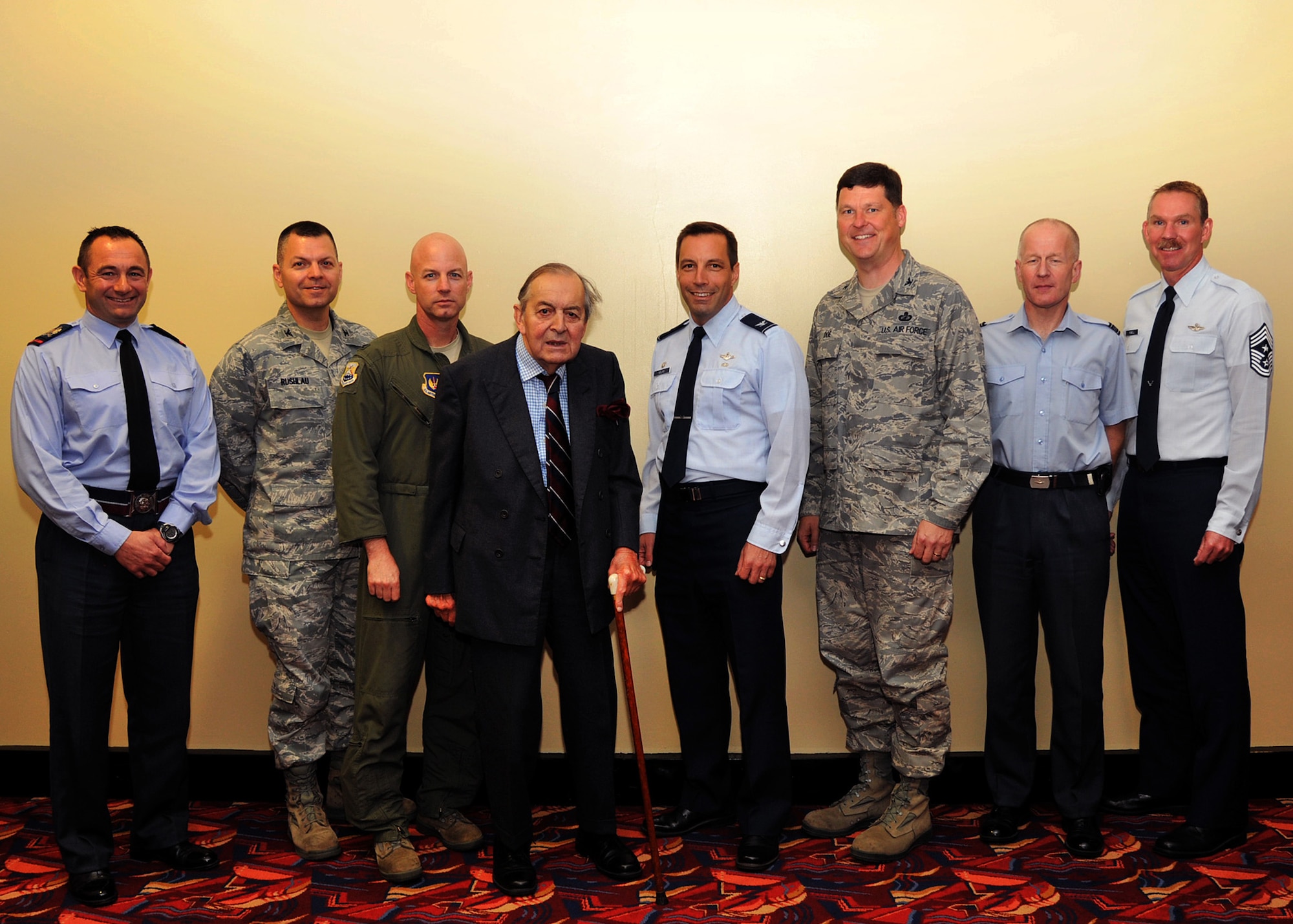 RAF MILDENHALL, England – Sir Michael Beetham, (center) poses with 100 Air Refueling Wing leadership and (left) Station Warrant Officer Paul Edwards, RAF Marham, for a group photo at the Galaxy Club here Oct. 11, 2011. Beetham, a former bomber pilot, served during World War II and flew his first raid over Berlin at the age of 20. He held several leadership positions including Chief of the Air Staff, the highest rank in the Royal Air Force. He retired in 1982 after 41 years of military service. (U.S. Air Force photo/Senior Airman Jerilyn Quintanilla)