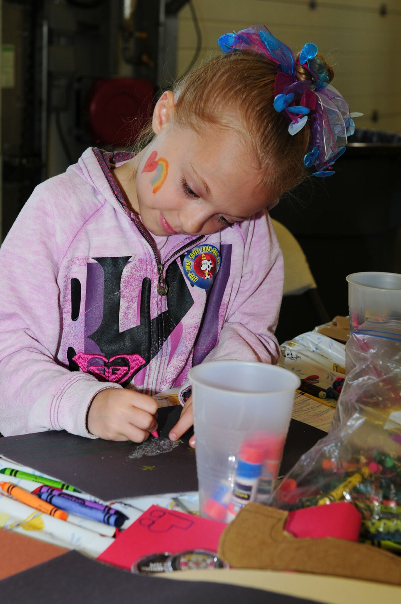 RAF MILDENHALL, England -- Allie Frederickson, 7, daughter of Tech. Sgt. Carrie Frederickson, 48th Civil Engineer Squadron, draws pictures and does crafts at the RAF Mildenhall Fire Department's open house event Oct. 10, 2011. The open house was part of Fire Prevention Week events, which also included a fire muster, Firefighter Gary and friends at the food court, and a visit to RAF Lakenheath's youth center. The week will conclude with a Team Mildenhall run Oct. 14. (U.S. Air Force photo by Karen Abeyasekere)