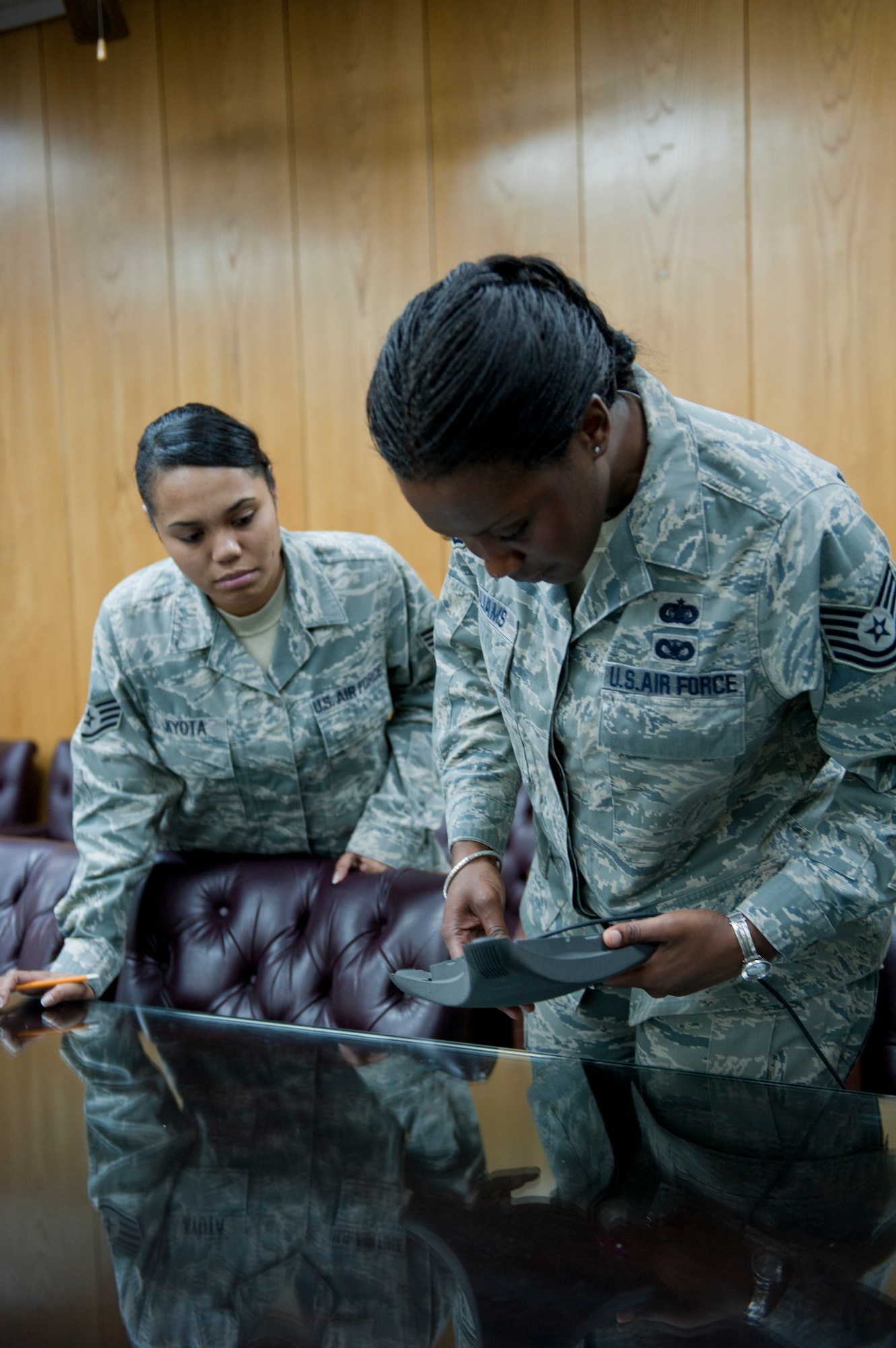 Tech. Sgt. Lakiesha Williams, right, and Staff Sgt. Vanessa Kyota, both 39th Mission Support Group knowledge operations management technicians, inspect a teleconference microphone receiver Oct. 11, 2011, at Incirlik Air Base, Turkey. KOMT members are the liaisons between the Client Systems Team and the 39th MSG staff members for creating and ensuring completion of communications related trouble tickets. (U.S. Air Force photo by Senior Airman Anthony Sanchelli/Released) 
