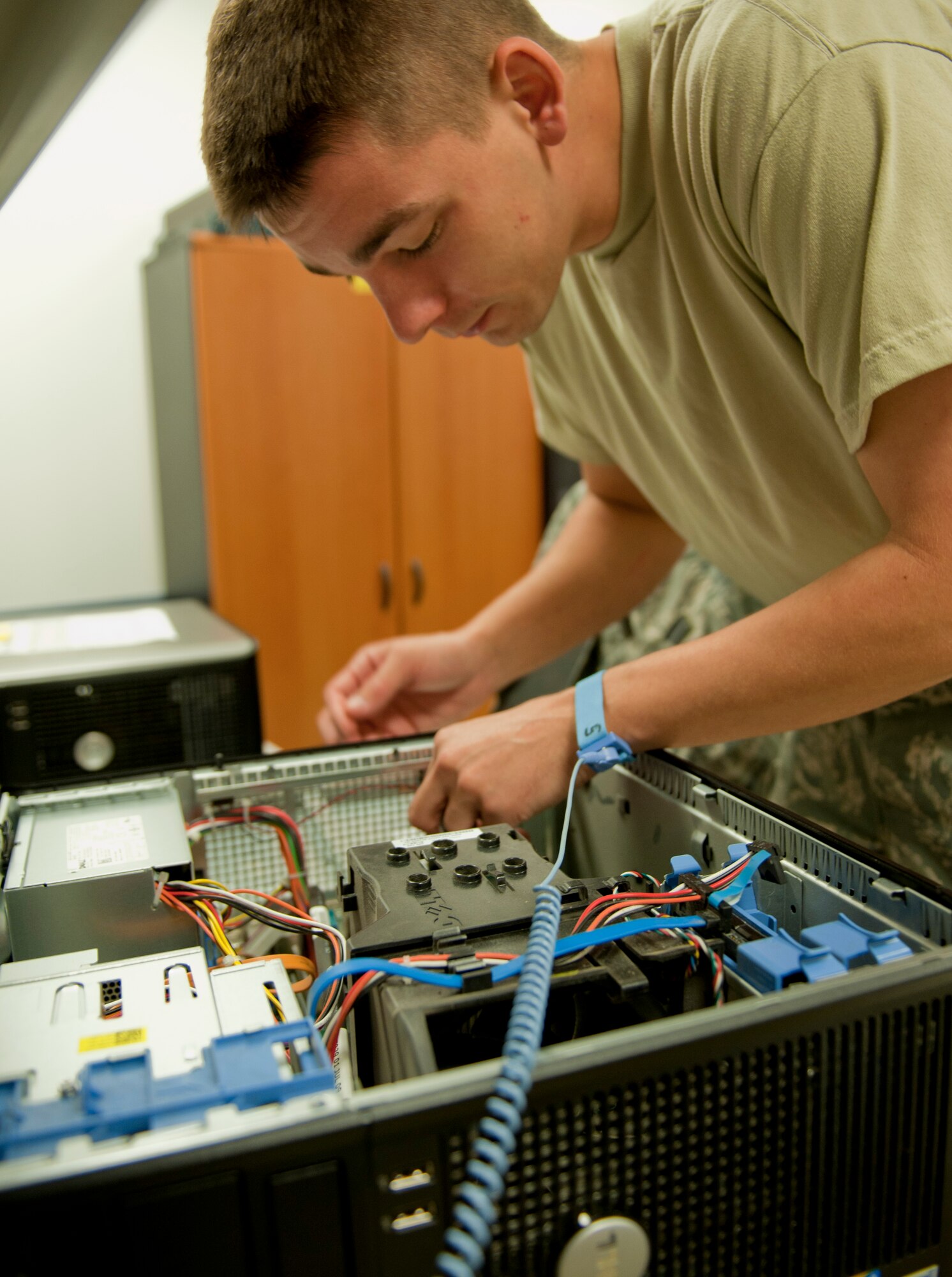 Airman 1st Class Mike Hareld, 39th Communications Squadron base equipment control officer, removes a faulty video card from a computer Oct. 11, 2011, at Incirlik Air Base, Turkey. As part of his equipment control duties, Hareld ensures computers are working properly before being used by units on base. (U.S. Air Force photo by Senior Airman Anthony Sanchelli/Released) 

