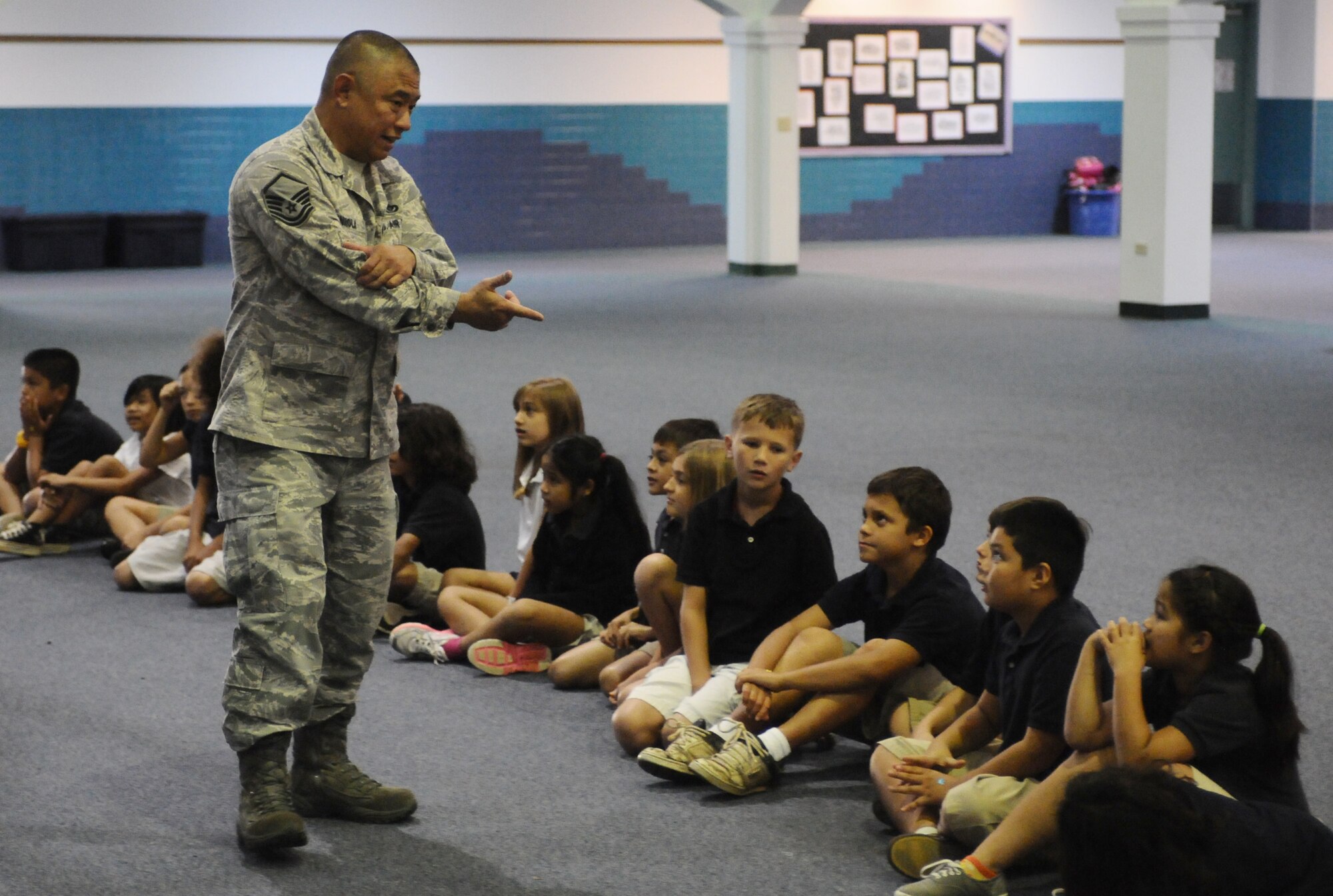 ANDERSEN AIR FORCE BASE, Guam—Master Sgt. Rudolph Mendiola, 36th Civil Engineer Squadron fire department member, answers questions from children during a visit to the Andersen Elementary School here, Oct. 13. Members of the Andersen Fire and Emergency flight visited the schools during Fire Prevention Week.  (U.S. Air Force photo by Senior Airman Benjamin Wiseman/Released)