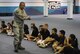 ANDERSEN AIR FORCE BASE, Guam—Master Sgt. Rudolph Mendiola, 36th Civil Engineer Squadron fire department member, answers questions from children during a visit to the Andersen Elementary School here, Oct. 13. Members of the Andersen Fire and Emergency flight visited the schools during Fire Prevention Week.  (U.S. Air Force photo by Senior Airman Benjamin Wiseman/Released)
