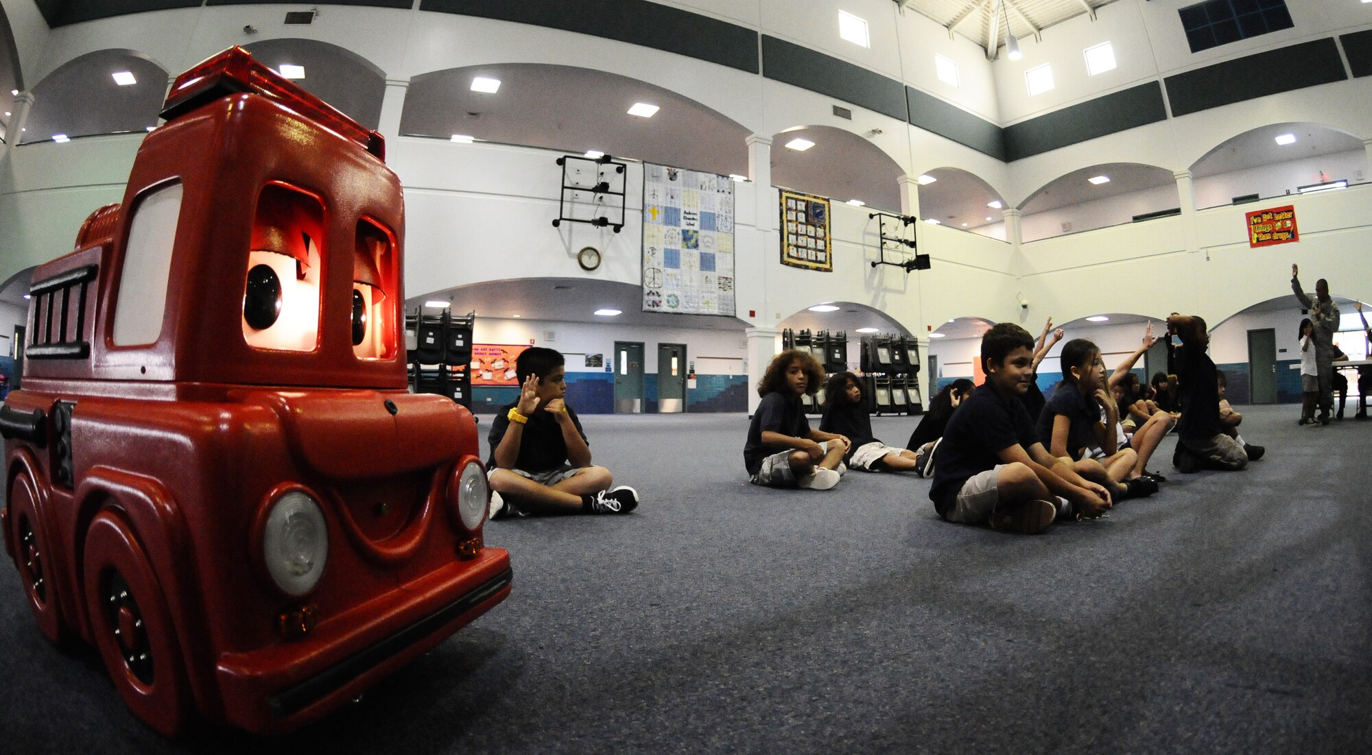 ANDERSEN AIR FORCE BASE, Guam—Andersen Elementary School children ask questions to members of the Andersen Fire and Emergency flight during a school visit for Fire Prevention Week here, Oct. 13. The Andersen Fire and Emergency flight held several events throughout the week to increase fire safety awareness. (U.S. Air Force photo by Senior Airman Benjamin Wiseman/Released)