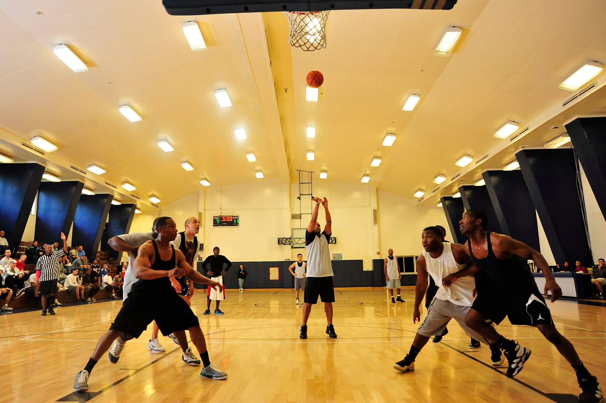 MISAWA AIR BASE, Japan -- Airmen from the 35th Maintenance Squadron and 373rd Intelligence, Surveillance and Reconnaissance Group, battle for position as Maurice Jones, 35 MXS, shoots a free throw during sports day here Oct. 7. The 35 FW held a sports day to promote physical fitness, teamwork, sportsmanship and esprit de corps. The day was kicked off with a 3-mile run followed by various sporting events to include relay races, basketball, softball, ultimate frisbee, soccer and a readiness competition. Approximately 14 units from the base formed teams to participate in each event. (U.S. Air Force photo by Staff Sgt. Nathan Lipscomb)