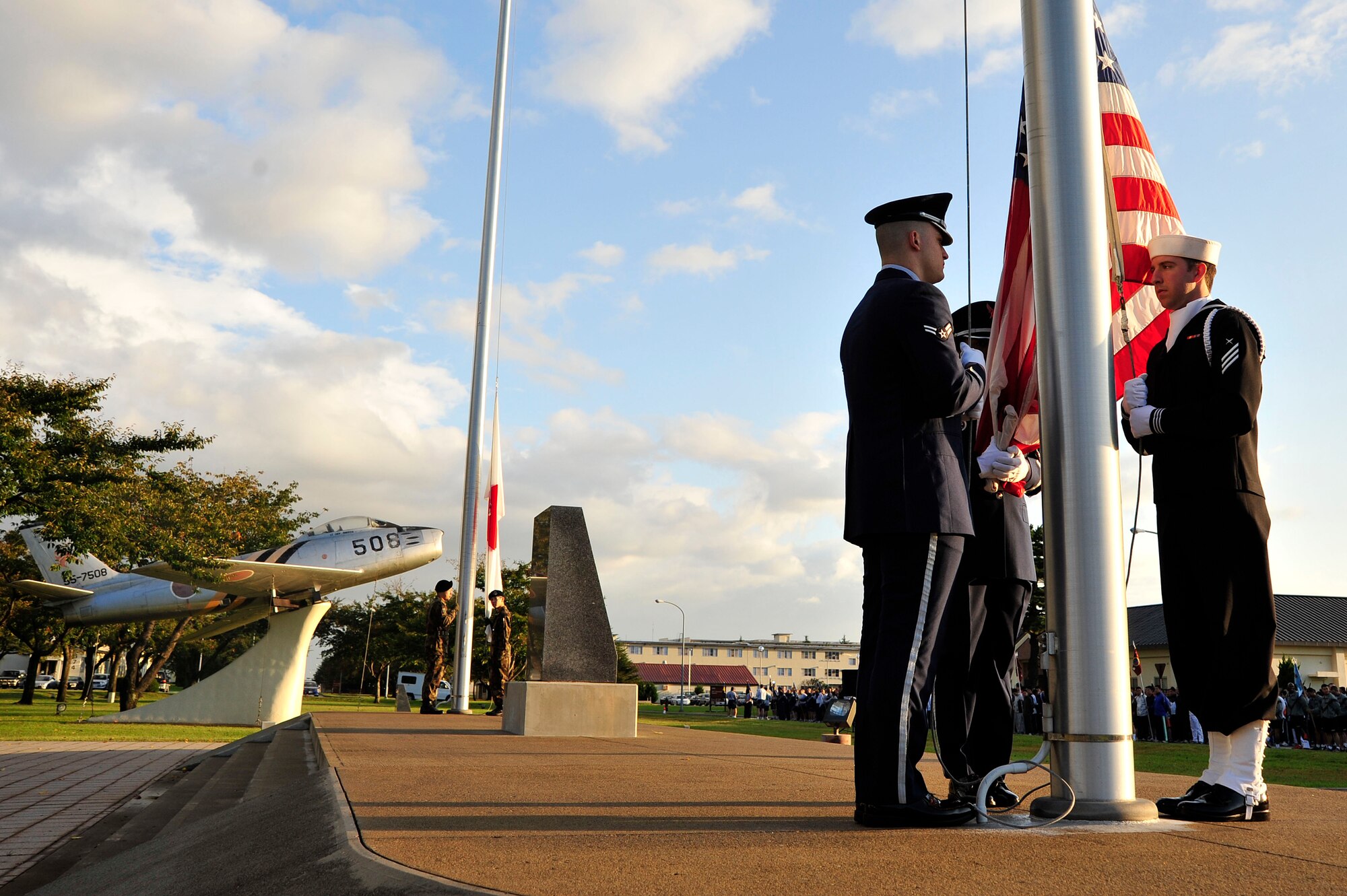 MISAWA AIR BASE, Japan -- Members of the U.S. Air Force, Navy and Japan Air Self-Defense Force honor guards prepare to raise the U.S. and Japanese flags during the opening ceremony of the 35th Fighter Wing Sports Day here Oct. 7. The 35 FW held a sports day to promote physical fitness, teamwork, sportsmanship and esprit de corps. The day was kicked off with a 3-mile run followed by various sporting events to include relay races, basketball, softball, ultimate frisbee, soccer and a readiness competition. Approximately 14 units from the base formed teams to participate in each event. (U.S. Air Force photo by Staff Sgt. Nathan Lipscomb)