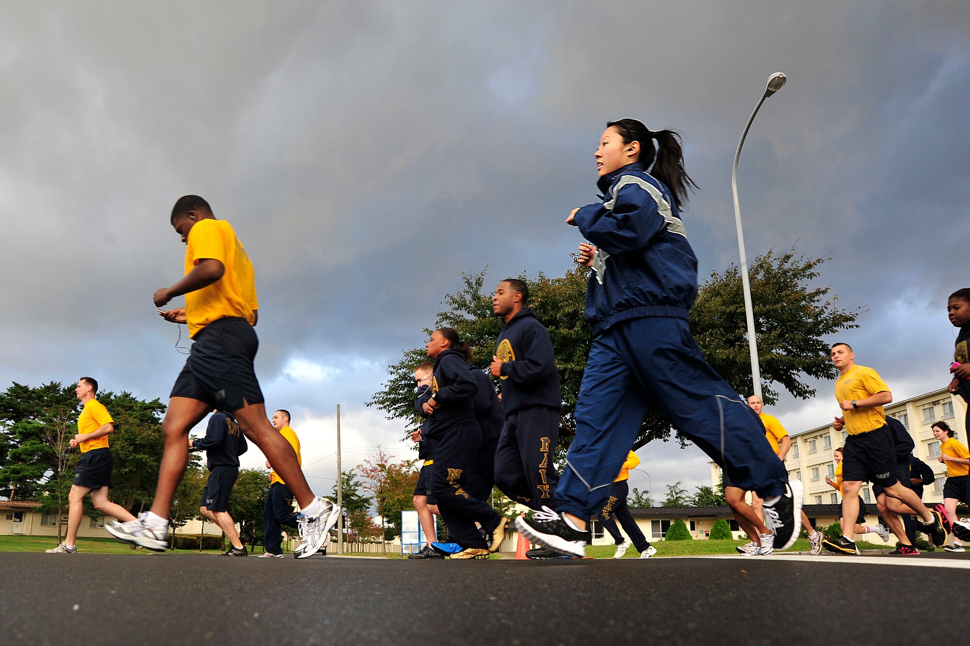 MISAWA AIR BASE, Japan -- Airmen and sailors start the 3-mile run as the first event of sports day here Oct. 7. The 35th Fighter Wing held a sports day to promote physical fitness, teamwork, sportsmanship and esprit de corps. The day was kicked off with a 3-mile run followed by various sporting events to include relay races, basketball, softball, ultimate frisbee, soccer and a readiness competition. Approximately 14 units from the base formed teams to participate in each event. (U.S. Air Force photo by Staff Sgt. Nathan Lipscomb)