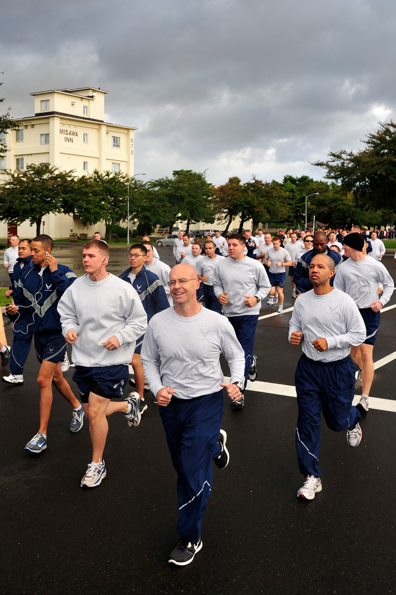 MISAWA AIR BASE, Japan -- Airmen from the 35th Fighter Wing run during sports day here Oct. 7. The 35 FW held a sports day to promote physical fitness, teamwork, sportsmanship and esprit de corps. The day was kicked off with a 3-mile run followed by various sporting events to include relay races, basketball, softball, ultimate frisbee, soccer and a readiness competition. Approximately 14 units from the base formed teams to participate in each event. (U.S. Air Force photo by Staff Sgt. Nathan Lipscomb)