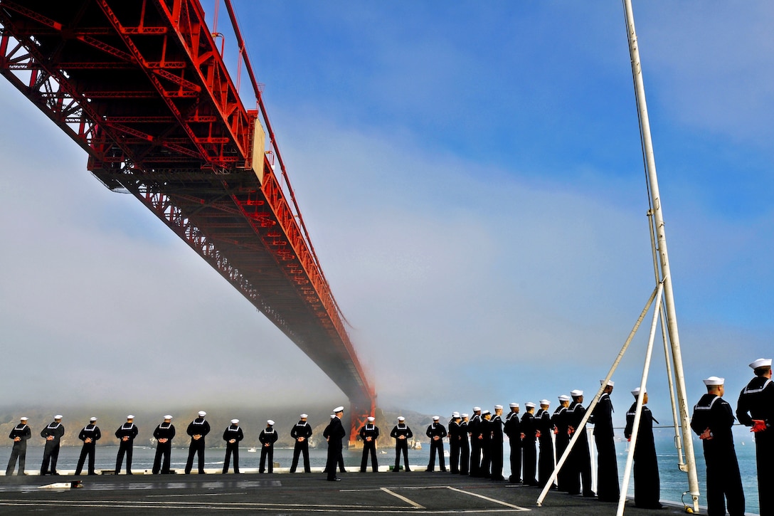 Sailors man the rails aboard the aircraft carrier USS Carl Vinson as the ship passes under the Golden Gate Bridge in San Francisco, Oct. 6, 2011. The Carl Vinson is participating in San Francisco Fleet Week 2011, a five-day event highlighting the equipment, technology and operational capabilities of the military's sea services and its history in the San Francisco area.