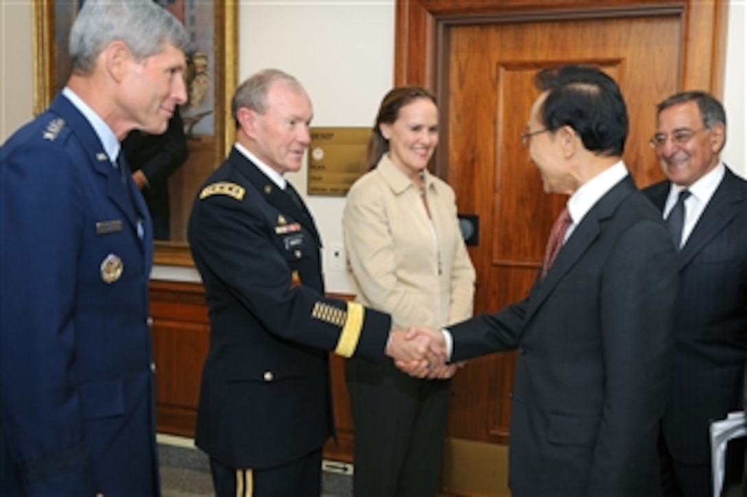 South Korean President Lee Myung-bak shakes hands with Chairman of the Joint Chiefs of Staff Gen. Martin E. Dempsey, U.S. Army, shortly after his arrival at the Pentagon in Arlington, Va., on Oct. 12, 2011. Lee and Panetta will meet with members of the Joint Chiefs of Staff and senior Department of Defense leaders in the Joint Chiefs conference room commonly known as The Tank.  Also in the receiving line is Under Secretary of Defense for Policy Michele Flournoy, and Air Force Chief of Staff Gen. Norton A. Schwartz.  
