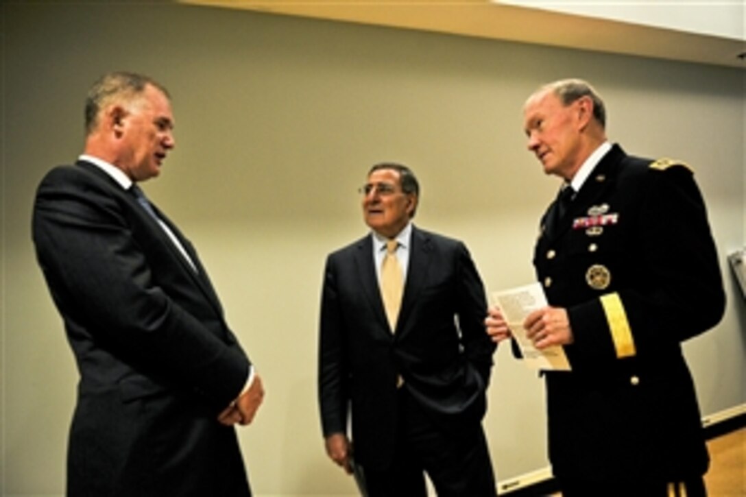 Former Deputy Defense Secretary William J. Lynn III, left, talks with Defense Secretary Leon E. Panetta and Army Gen. Martin E. Dempsey, chairman of the Joint Chiefs of Staff, before attending a farewell ceremony in Lynn's honor at the Pentagon, Oct. 13, 2011.