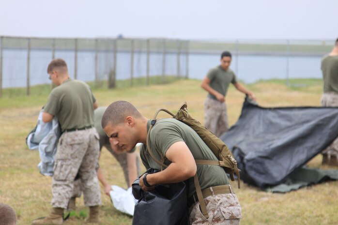 Marine Aircraft Group 12 Marines unroll and prepare to set up tents for the MAG-12 Operation Center exercise at Penny Lake Fields here Oct. 13. Marines were intentionally given the training in the command and control systems course of the MOC to bring the Marines closer to the deployed experience.