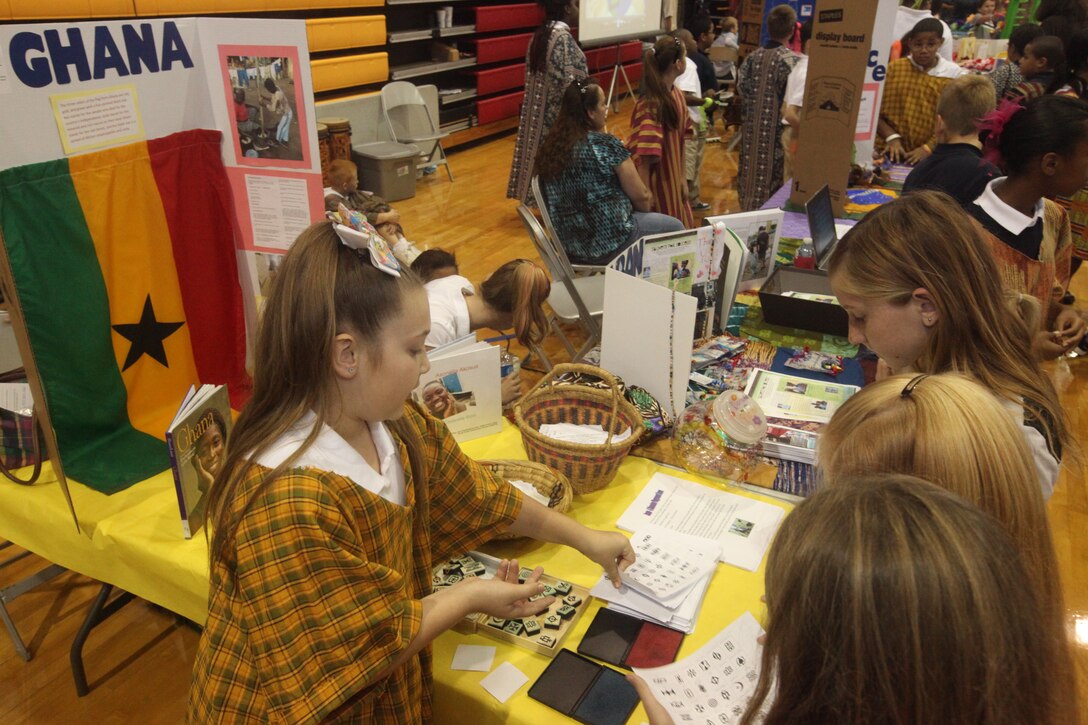 A young girl teaches her peers about culture and traditions in Ghana during the second annual Multi-Cultural Heritage Day celebration at the Goettge Memorial Field House, aboard Marine Corps Base Camp Lejeune, Oct. 14.