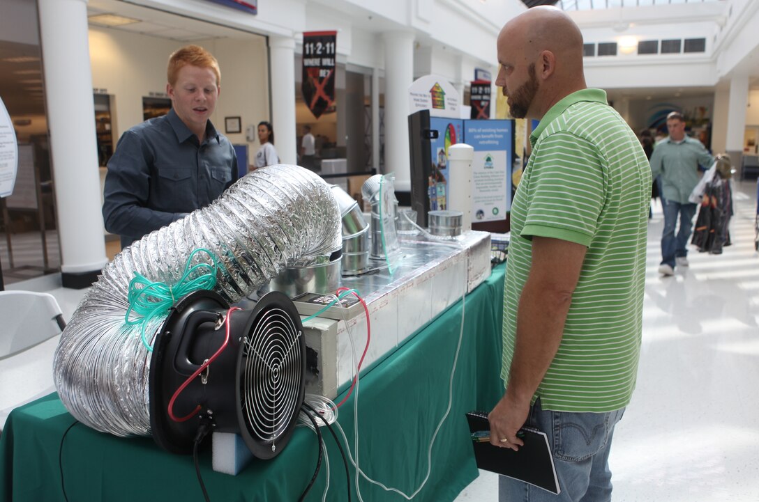 An attendant of the first Energy Fair held at the Marine Corps Exchange aboard Marine Corps Base Camp Lejeune observes one of the interactive and engaging displays, Oct. 14. The base Energy Fair was the first of its kind to specifically target energy related technologies and the Department of Defense and Marine Corps energy reduction vision.