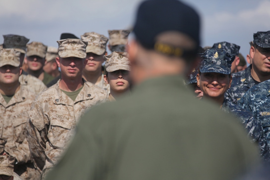 Marines with Combat Logistics Battalion 7 present their company colors aboard Camp Dwyer, Afghanistan, during a formation at which the 2nd Marine Logistics Group (Forward) commanding general, Brig. Gen. Michael G. Dana, addressed the Marines and highlighted their accomplishments, Oct. 14.  Combat Logistics Battalion 7 completed their seven-month deployment and transferred authority to CLB-1.  (U.S. Marine Corps photo by Cpl. Katherine M. Solano)