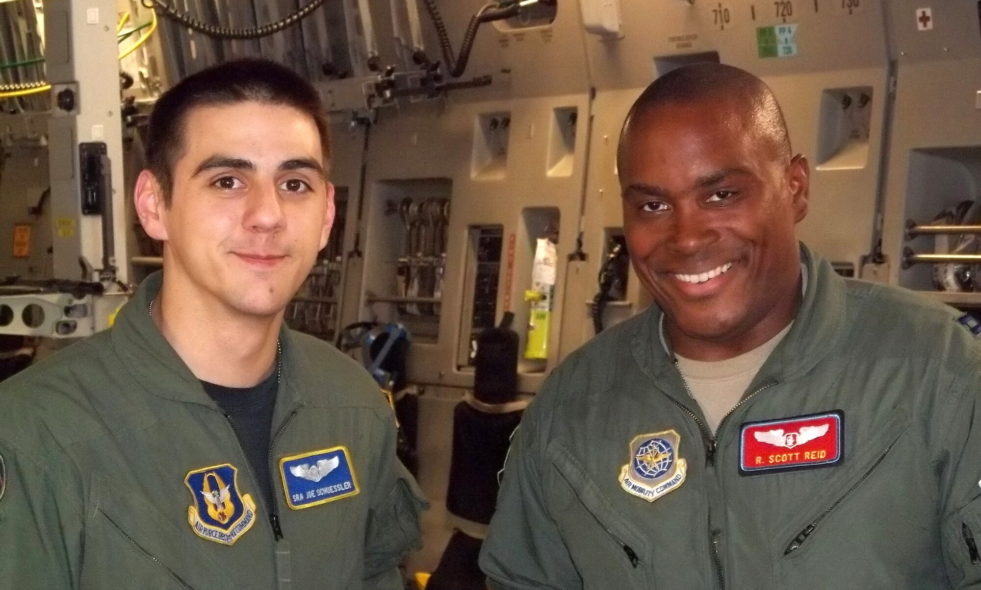 Senior Airman Joseph Schuessler (left), a loadmaster with the 313th Airlift Squadron, McChord Field, Wash., stands with Capt. Rodrick Reid, 775th Expeditionary Aeromedical Evacuation Flight flight nurse in a C-17 Globemaster III, Oct. 11, 2011. The two Airmen were supporting an Integrated Continental U.S. Medical Operations Plan mission, which takes troops injured from the area of responsibility from Joint Base Andrews, Md. to military installations for definitive care. (U.S. Air Force photo by Chief Master Sgt. Ronald Campeau)