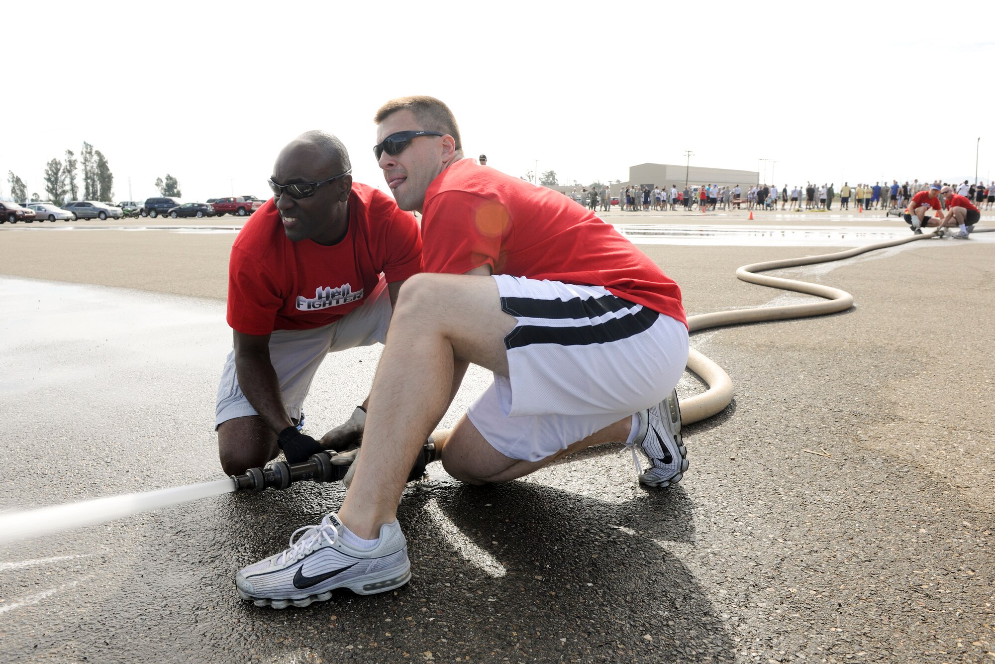 VANDENBERG AIR FORCE BASE, Calif. – Capt. Sean Ballard and Capt. Shane Walker, both 30th Space Wing chaplains, spray down a traffic cone during the Fire Muster competition at the parade grounds here Friday, Oct. 14, 2011. The Fire Muster competition is held during Vandenberg’s Fire Prevention week to help demonstrate the physical and mental struggles that firefighters go through. (U.S. Air Force/Staff Sgt. Levi Riendeau)