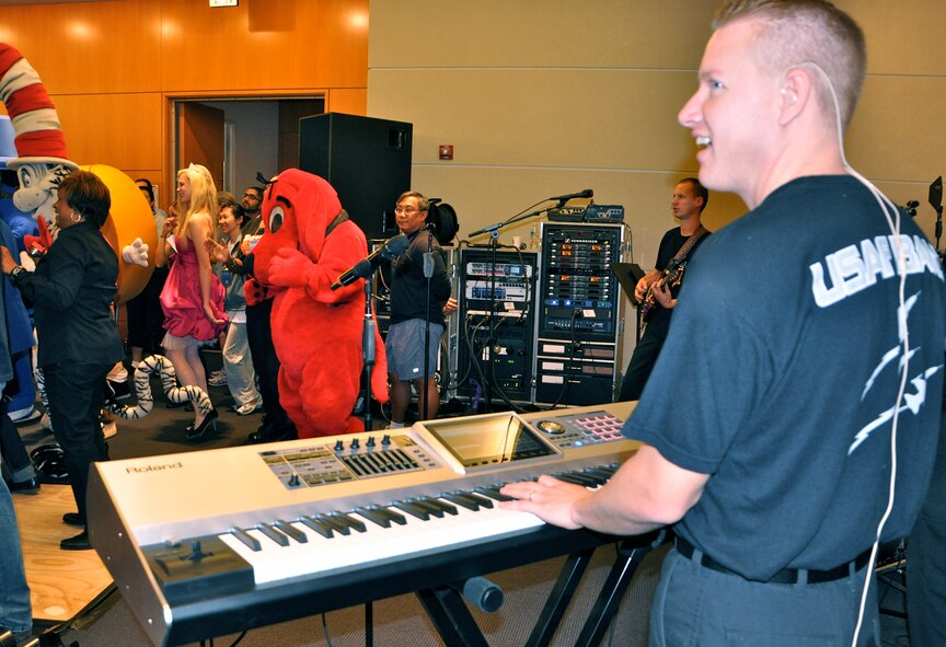 Master Sgt. Jonathan MacPherson, keyboard player for the U.S. Air Force band “Max Impact,” performs along with his band members for more than 600 spectators during the 2011 U.S. Patent and Trademark Office National Trademark Expo Oct. 14, 2011 at the USPTO headquarters building in Alexandria, Va. The U.S. Air Force Trademark and Licensing program represented the Air Force at the expo, displaying a booth and providing information about the program. (U.S. Air Force photo by Staff Sgt. Alex Martinez)