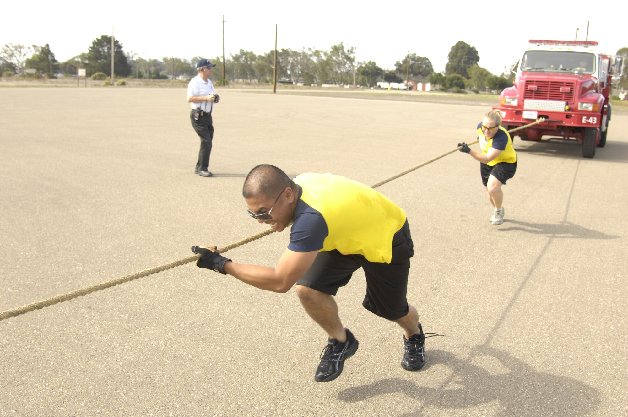 VANDENBERG AIR FORCE B ASE, Calif. – Staff Sgt. Julio Pequet with Capt. Laura Miz, both of the 30th Civil Engineer Squadron, pull an engine during the fire engine pull to claim first prize at this year’s Fire Muster competition here Friday, Oct. 14, 2011. More than 100 participants made up 21 teams in this year’s competition in support of National Fire Prevention Week. (U.S. Air Force photo/Senior Airman Lael Huss)