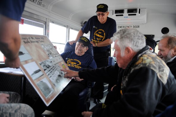 Seven members of the 50th anniversary “POL” military reunion reflect on what the base looked like during their tour of duty while on their return tour of Mountain Home Air Force Base, Idaho, Oct. 7, 2011. All seven members told stories about sleeping on cold concrete floors in shifts and polishing metal barrels so well that they could be eaten off of while they served together in the 366th Logistics Readiness Squadron Fuels Flight from 1959 to 1963. (U.S. Air Force photo by Senior Airman Angelina Drake/Released)