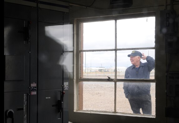 On Oct. 7, 2011, Elisha Robinette, a member of the 50th anniversary “POL” military reunion, stands outside the only unchanged building since being stationed at Mountain Home Air Force Base, Idaho. Robinette served four years at MHAFB from 1959 to 1963. (U.S. Air Force photo by Senior Airman Angelina Drake/Released)