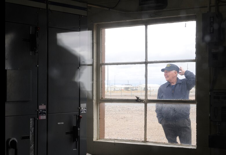 On Oct. 7, 2011, Elisha Robinette, a member of the 50th anniversary “POL” military reunion, stands outside the only unchanged building since being stationed at Mountain Home Air Force Base, Idaho. Robinette served four years at MHAFB from 1959 to 1963. (U.S. Air Force photo by Senior Airman Angelina Drake)