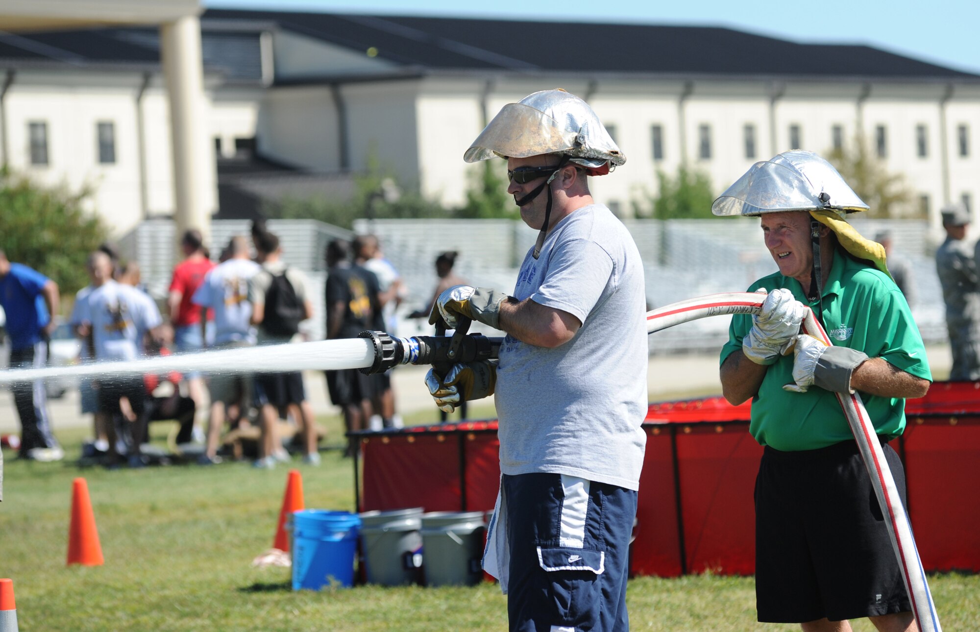 Master Sgt. Michael Asdel and Tom Golden, both from the 81st Force Support Squadron, work together during the "Hot Shots" competition at the Fire Muster Oct. 14, 2011, Keesler Air Force Base, Miss.  The Fire Muster is an event sponsored by the Keesler Fire Department in conjunction with Fire Prevention Week Oct. 11-15.  (U.S. Air Force photo by Kemberly Groue)