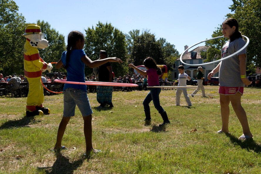 Sparky and Team Barksdale children, play with hoola hoops during Celebrate Barksdale on Barksdale Air Force Base, La., Oct. 14. Sparky, the fire safety mascot, made a special appearance at the event as part of Fire Prevention Week.. (U.S. Air Force photo/Airman 1st Class Benjamin Gonsier)(RELEASED)