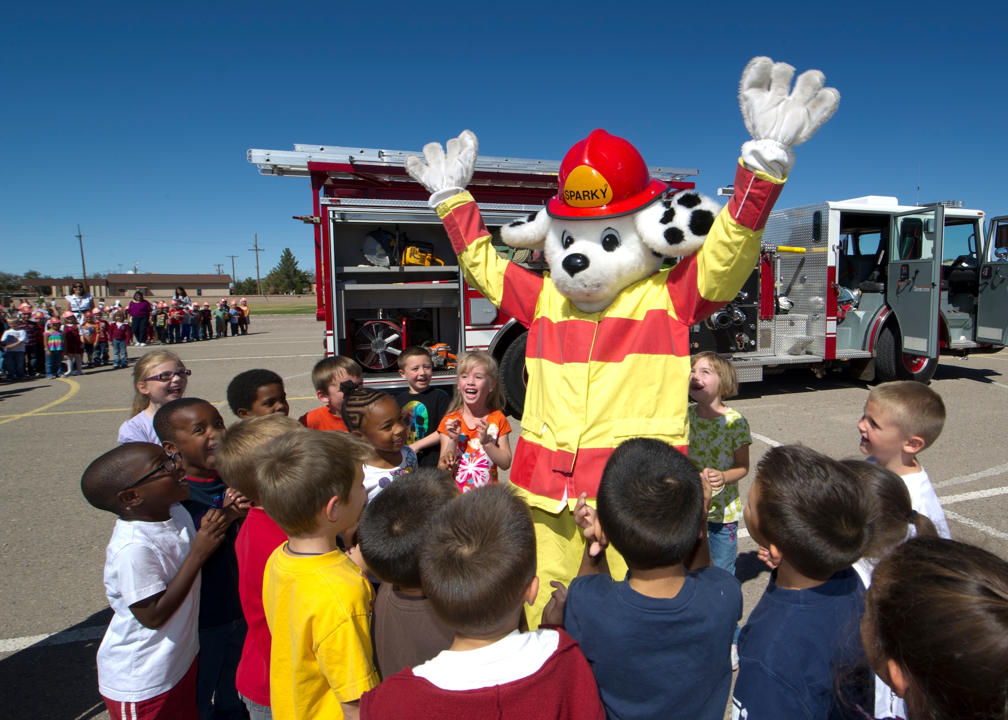 HOLLOMAN AIR FORCE BASE, N.M. -- Sparky the Fire Dog greets students from Holloman Elementary School Oct. 12, 2011, after a fire drill was conducted to promote Fire Prevention Week. Firefighters from the 49th Civil Engineer Squadron hosted an open house at their fire station, conducted fire evacuation drills at various facilities on base, and had Sparky welcome members of Team Holloman at the front gate to raise awareness for fire safety. (U.S. Air Force photos by Senior Airman Veronica Stamps/Released)