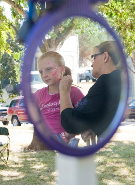 Neecee Blackwell paints a child's face during Celebrate Barksdale on Barksdale Air Force Base, La., Oct. 14. The Military Affairs Council sponsored event featured family activities in appreciation of Barksdale Airmen and their families and the sacrifices they make. (U.S. Air Force photo/Airman 1st Class Benjamin Gonsier)(RELEASED)