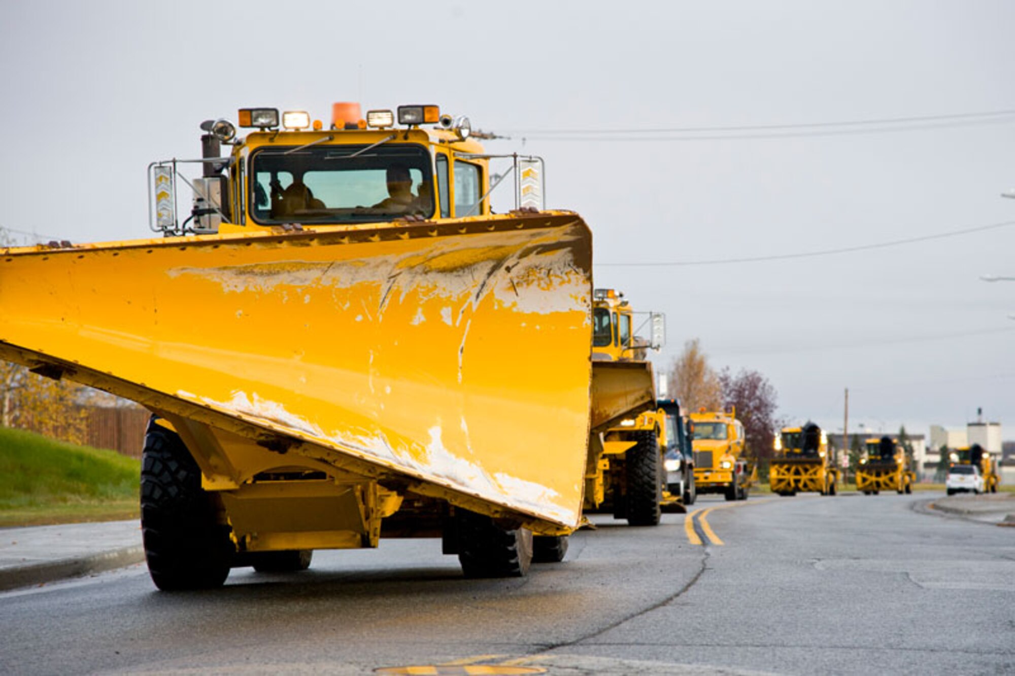 A 773rd Civil Engineer Squadron plow leads other snow removal equipment down Fighter Drive, before parking at the Joint Base Elmendorf-Richardson snow barn, Oct. 7. The 773rd CES took snow removal equipment on a tour around base to show residents the machinery they may see during the winter. During inclement weather, call 552-INFO or visit JBER’s Facebook for road conditions. Roads are graded from best to worst as green, yellow, red and black. Troops and civilian employees should contact supervisors for reporting information during adverse weather conditions. (U.S. Air Force photo/Johnathon Green)