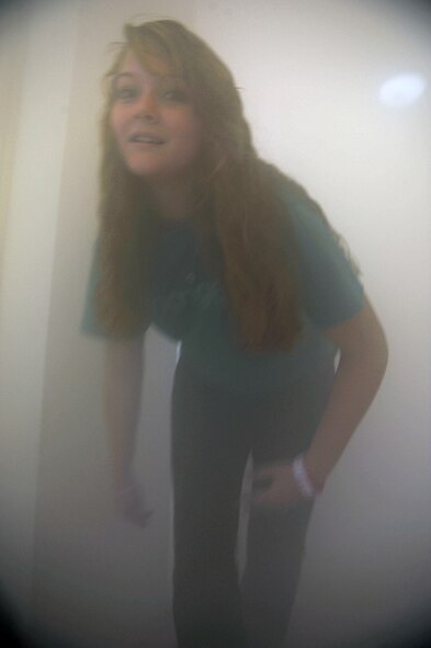 Brittany Williams, 18, from the Hendrix Home for Kids, goes through the ‘smoke house’ with simulated smoke from a fog machine Oct. 12, 2011 during Fire Prevention Week at Dyess Air Force Base, Texas. Fire Prevention Week is geared towards placing emphasis on fire and safety and is structured to reach the maximum amount of people in the Dyess Community. (U.S Air Force photo by Airman 1st Class Jonathan Stefanko/ Released)