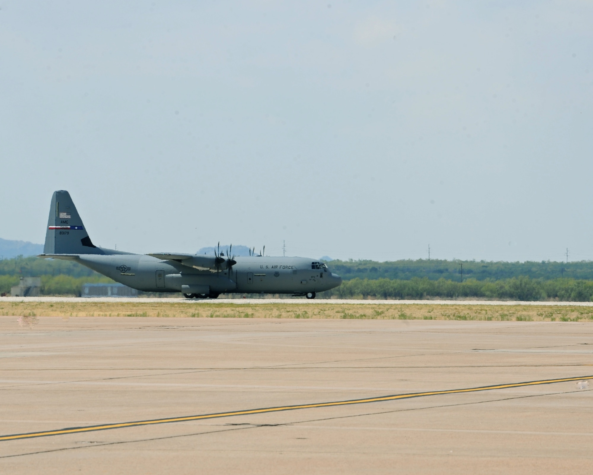 The newest C-130 J-model lands, Oct. 12, 2011, at Dyess Air Force Base, Texas. The aircraft is the ninth of 28 to be delivered to Dyess by 2013, replacing the current aging fleet of C-130 H models. (U.S. Air Force photo by Airman 1st Class Peter Thompson/Released)