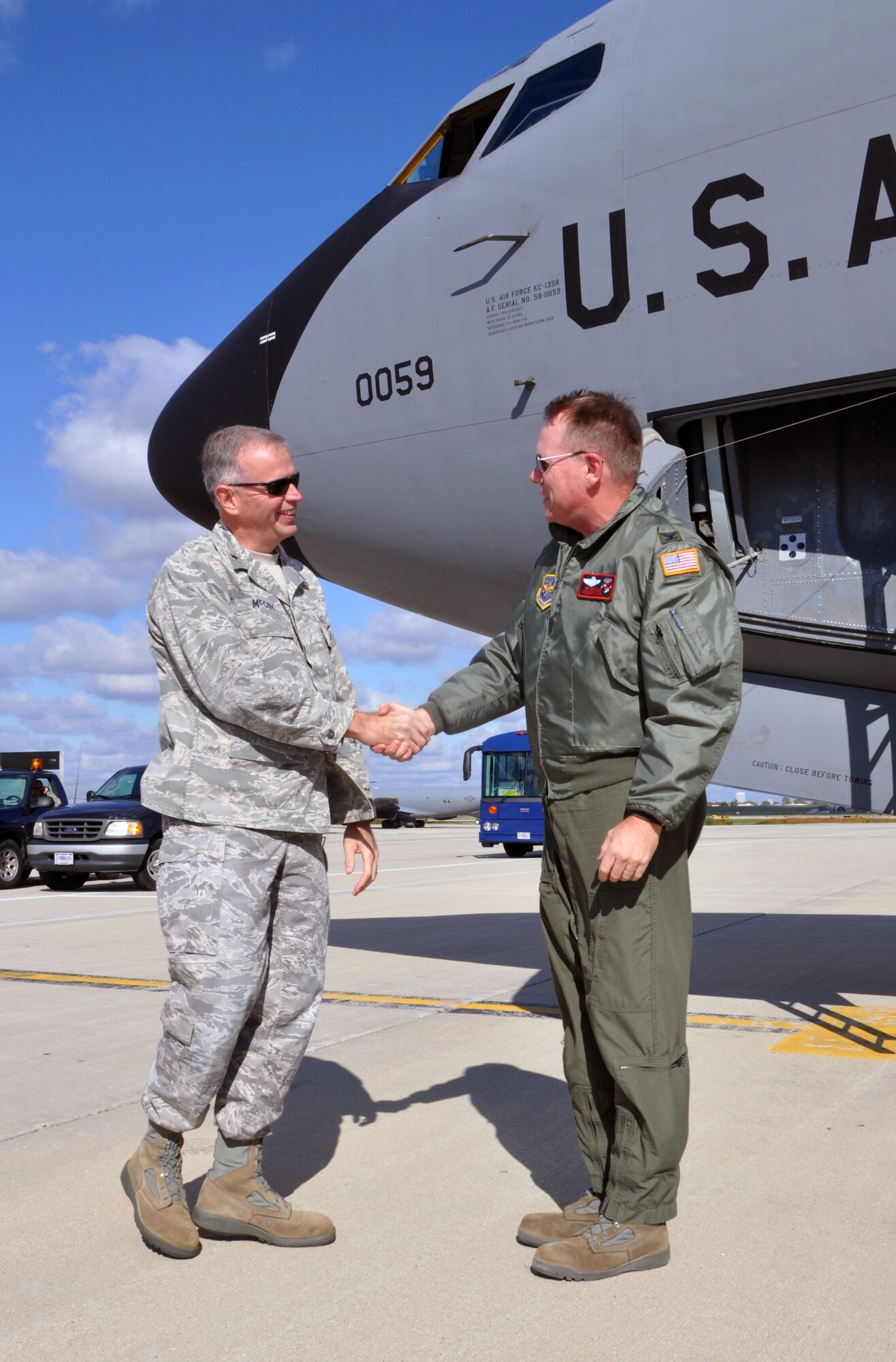 Brig. Gen. John E. McCoy, Assistant Adjutant General for Air, Wisconsin Air National Guard(left) welcomes home Col. Ted Metzgar, Commander, 128th Air Refueling Wing after returning from a 4-month long deployment in Western Europe on Friday, October 14, 2011 at Gen. Mitchell Air National Guard Base, Milwaukee. While deployed Metzgar served as the commander of the 313th Air Expeditionary Wing, supporting Operation Unified Protector. (U.S. Air Force photo/Capt. John P. Capra)